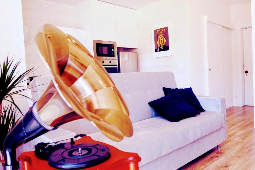 a living room with a white couch and a table at Aveiro, Ria e Fado in Aveiro