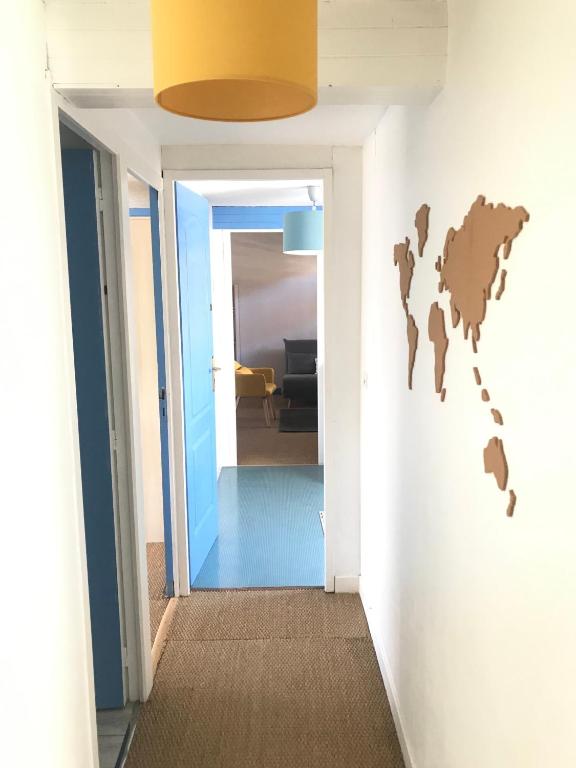 a hallway with a room with a world map on the wall at Grand et Charmant 3 pièces Breton Saint Brieuc Centre in Saint-Brieuc