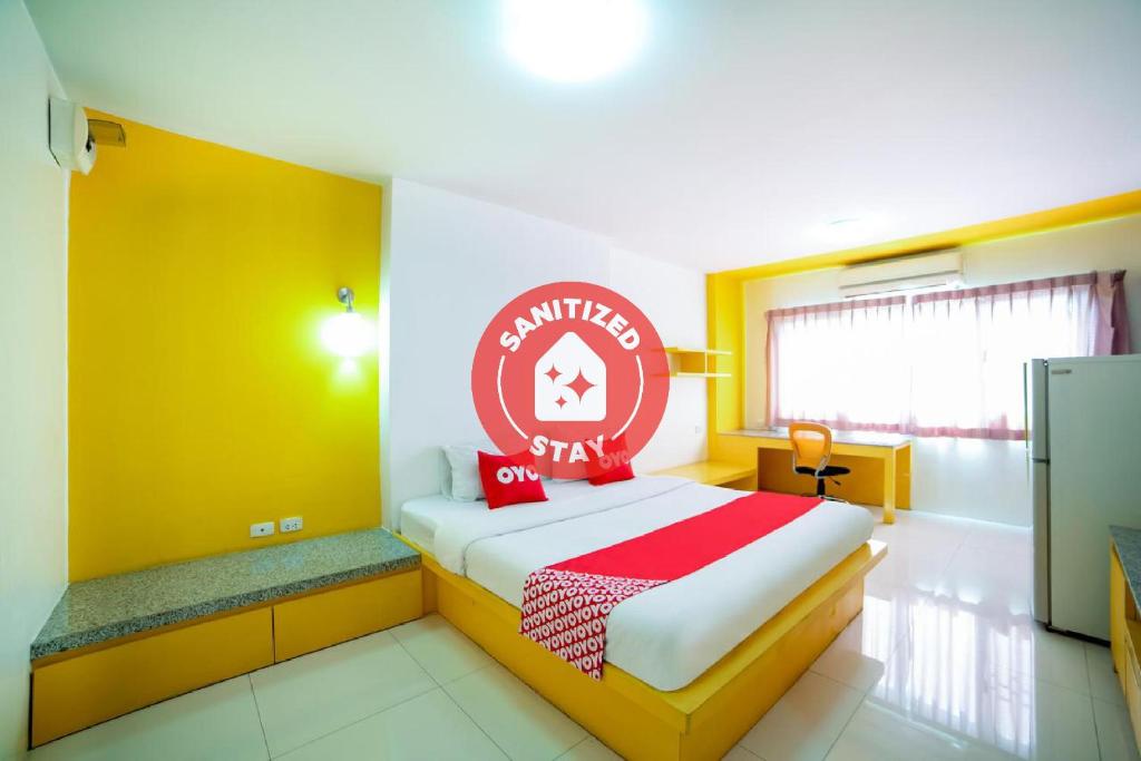 a bedroom with a bed with a red and yellow wall at OYO 460 Int Place in Bangkok