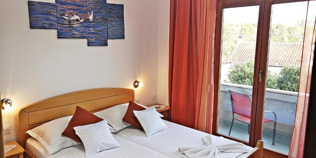 Łóżko lub łóżka w pokoju w obiekcie Apartments Bošković