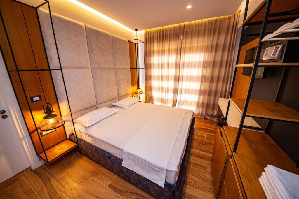 a bedroom with a large white bed in a room at Inada Hotel Ksamil in Ksamil