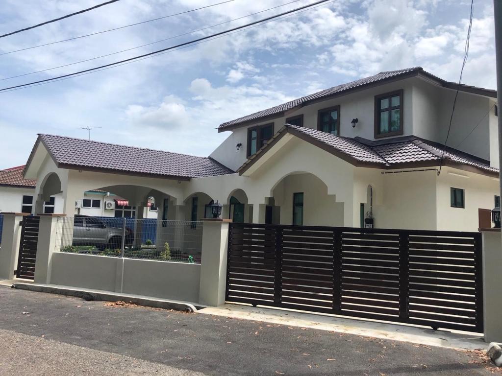 a house with a fence in front of it at DV Villa @ Angsana Sari in Sungai Petani