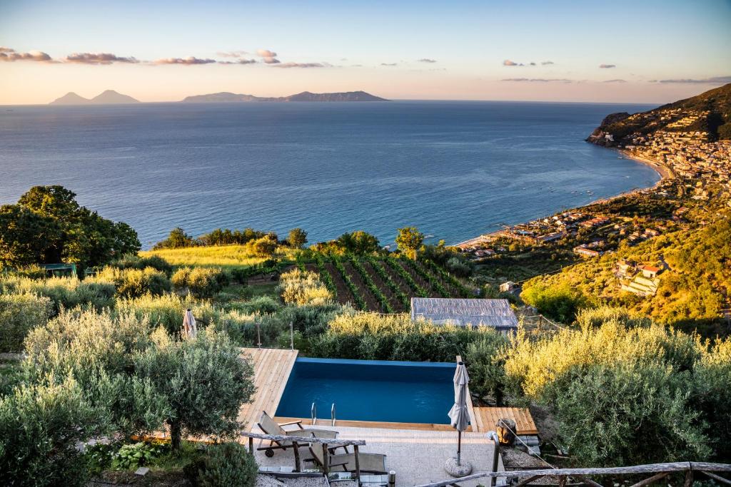 a villa with a swimming pool and a view of the ocean at Just be in Piraino