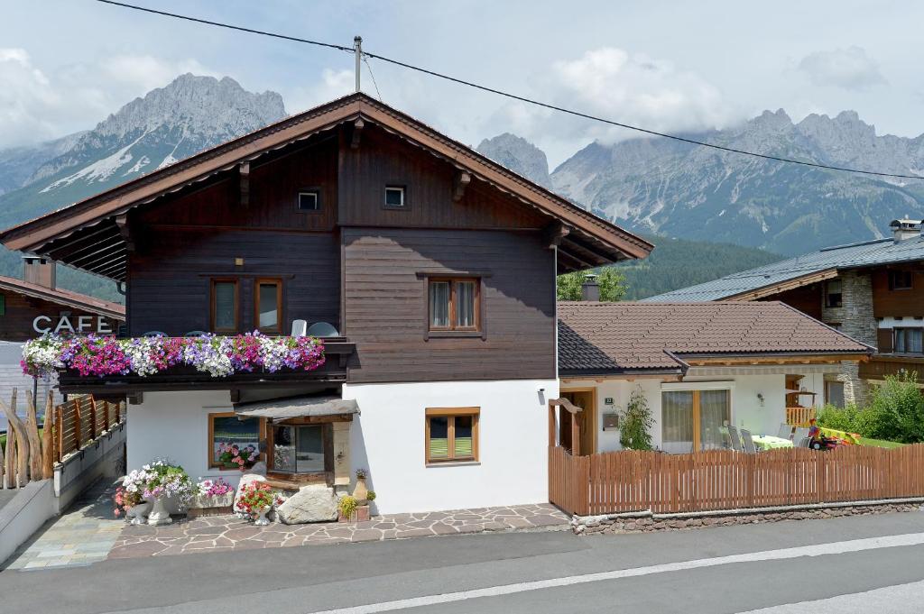 una casa con flores a un lado. en Appartement Gratt en Ellmau