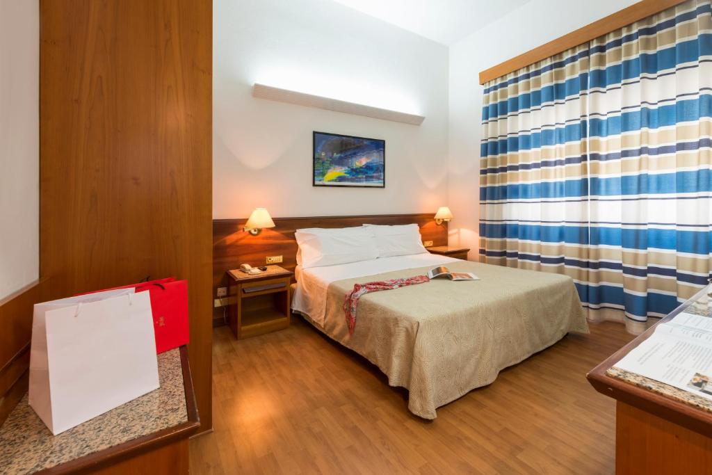 Postel nebo postele na pokoji v ubytování Hotel Giulia