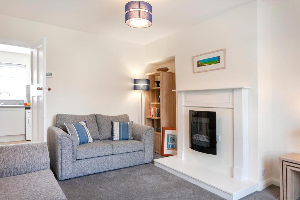 a living room with a couch and a fireplace at CRANBROOK 28 in Nottingham