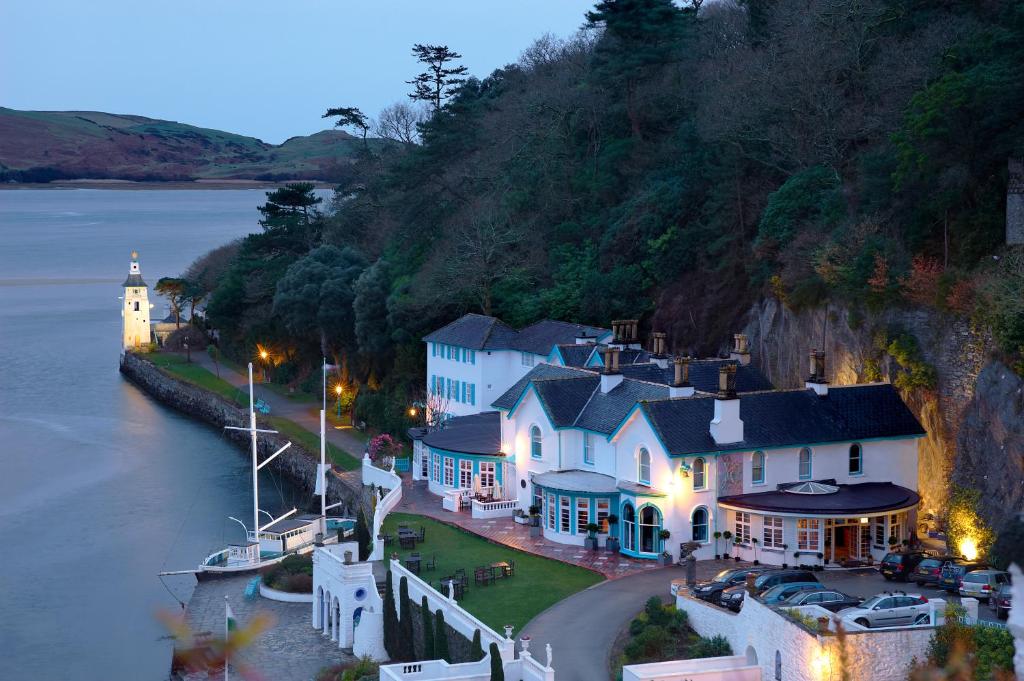 a small town on a hill next to the water at Portmeirion Village & Castell Deudraeth in Porthmadog