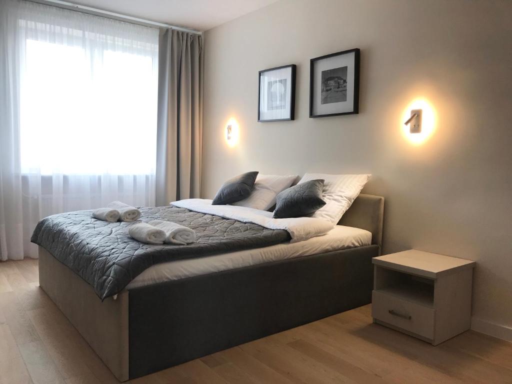 a bedroom with a large bed with a window at Widok Kielce in Kielce