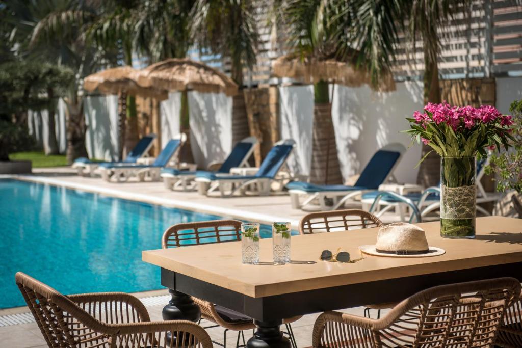 a table and chairs next to a swimming pool at Danaides in Malia
