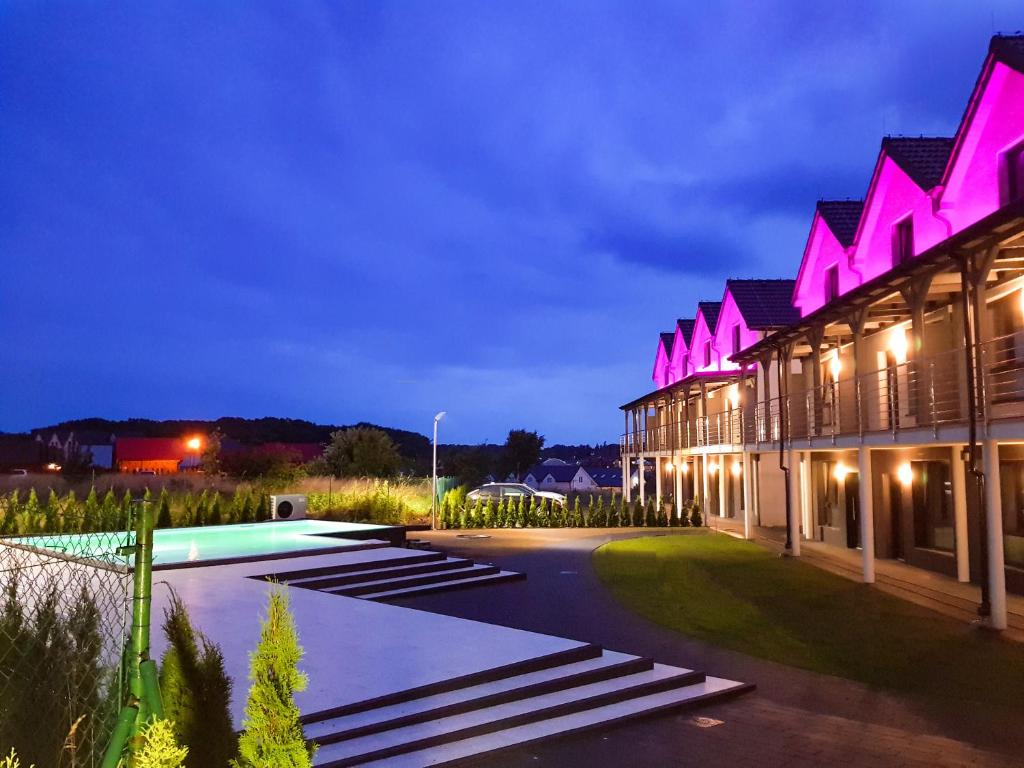 a night view of a building with purple lights at Baltic Seaside in Rewal