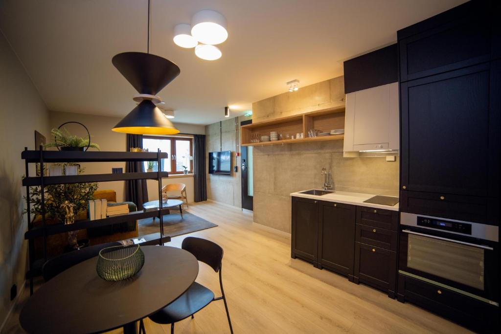 a kitchen with a table and a dining room at Home Again Apartments Kirkegata in Stavanger