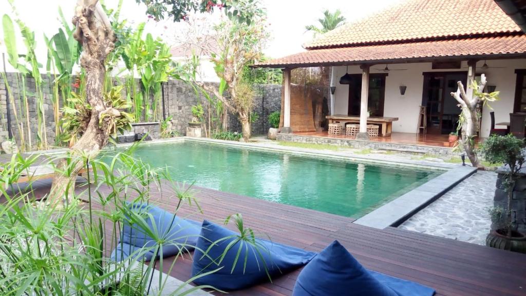 a swimming pool in front of a house at Villa Aquin in Solo