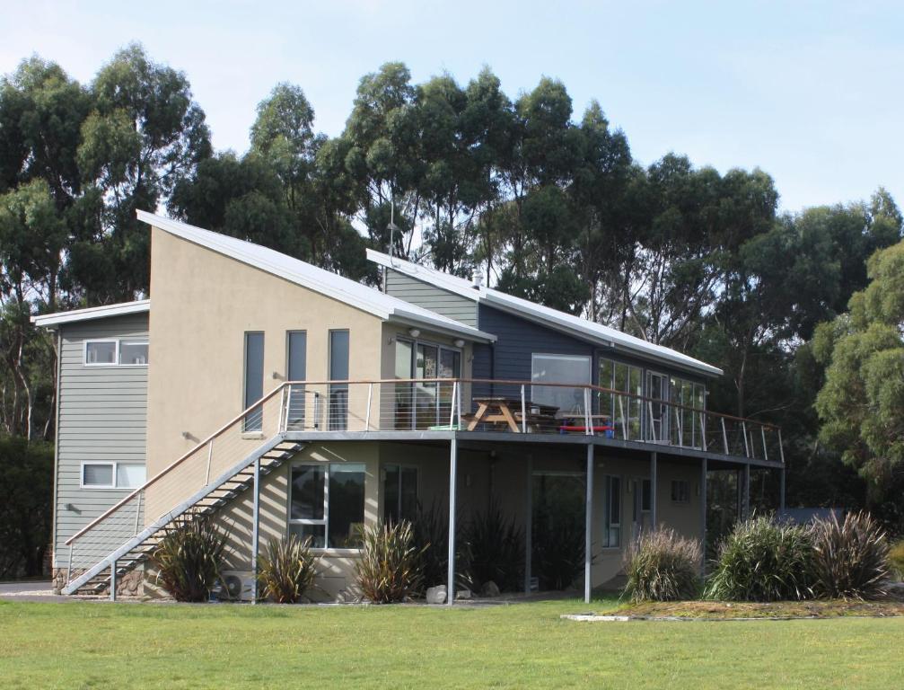 a house with a deck and a balcony at Harbour Lookout in Strahan