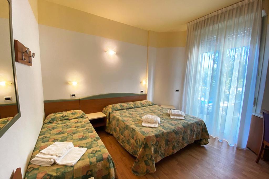 Postel nebo postele na pokoji v ubytování Hotel Diplomatic