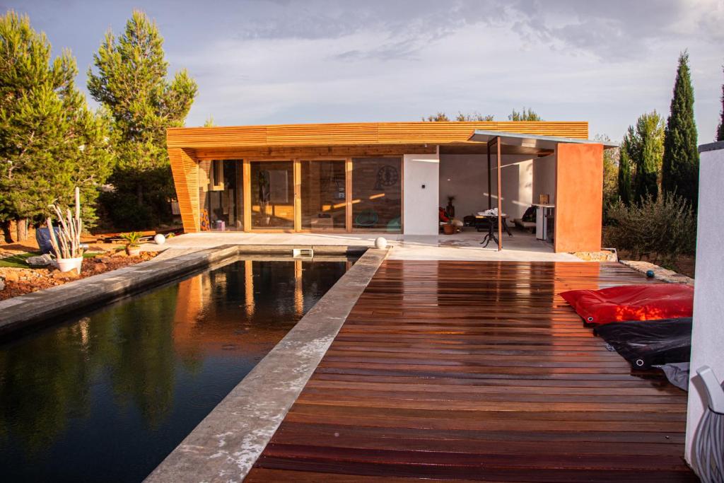 a house with a pool in front of a house at 4u Bed &amp; Spa in Opoul-Périllos