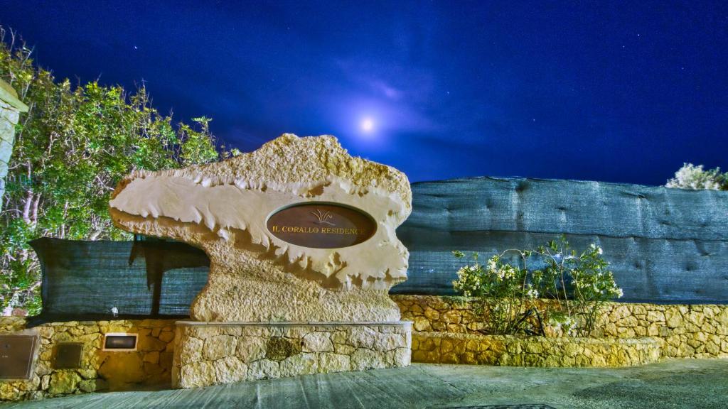 a building with a sign on it at night at Residence Il Corallo - Guitgia in Lampedusa