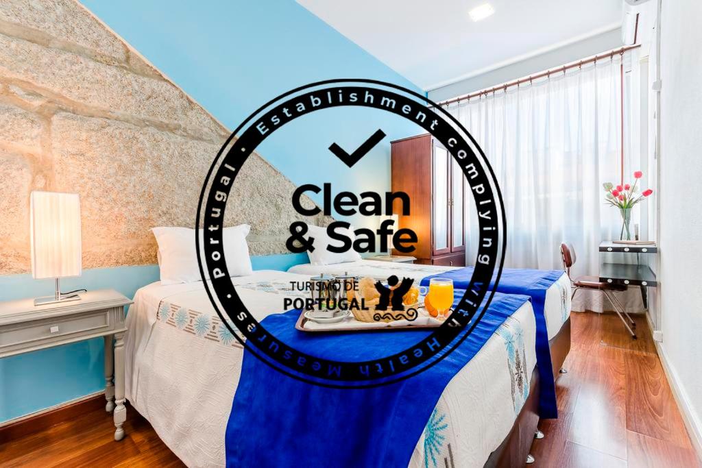 a sign that says clean and safe in a bedroom at Santa Clara Porto in Porto