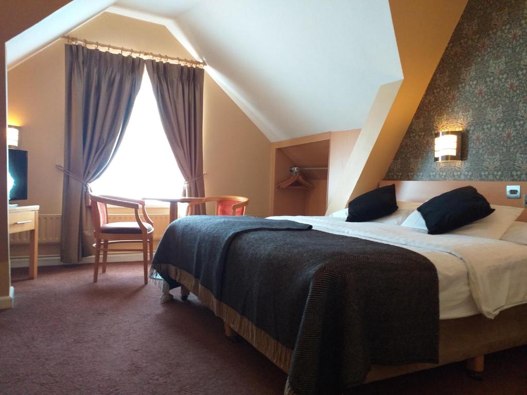 Postel nebo postele na pokoji v ubytování Harding Hotel