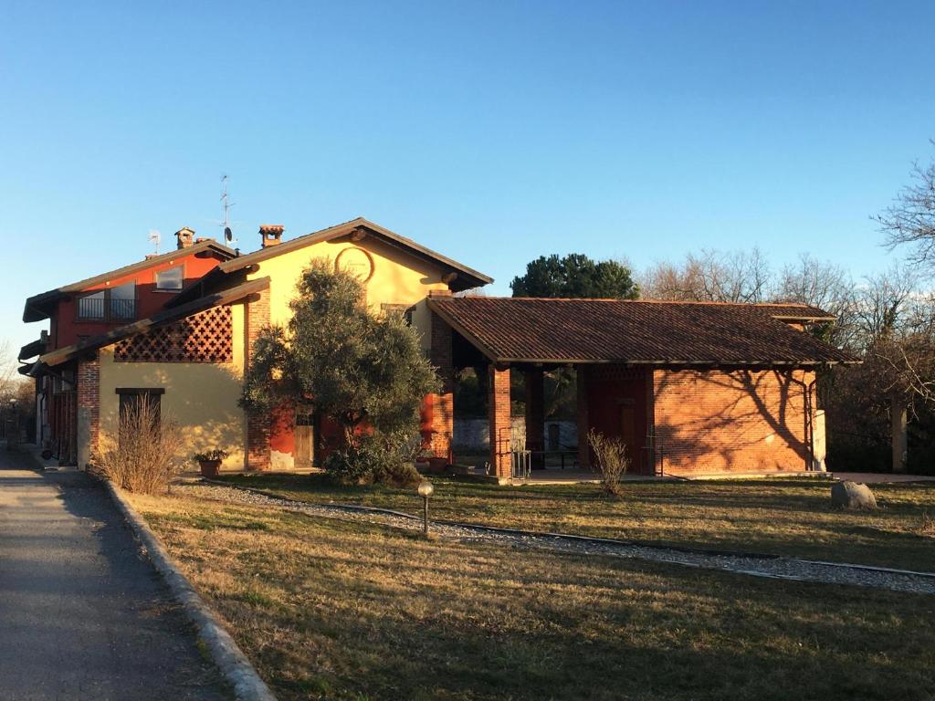 a house on the side of a grass field at Cascina Foresto in Cossato
