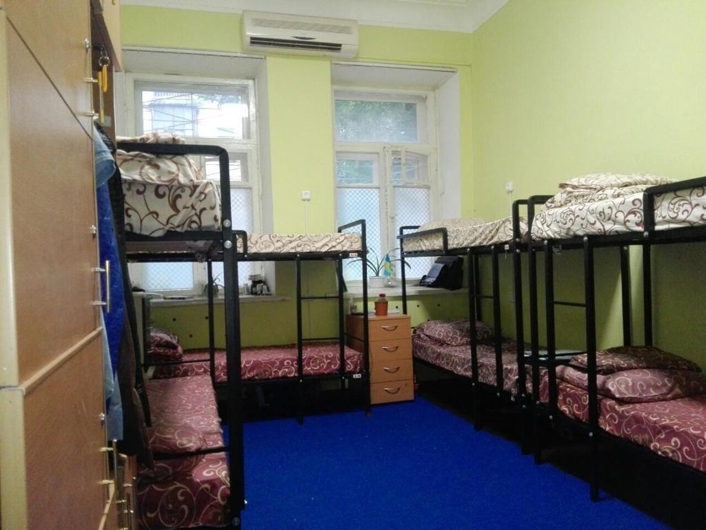 a room with three bunk beds and a window at Future in Kyiv