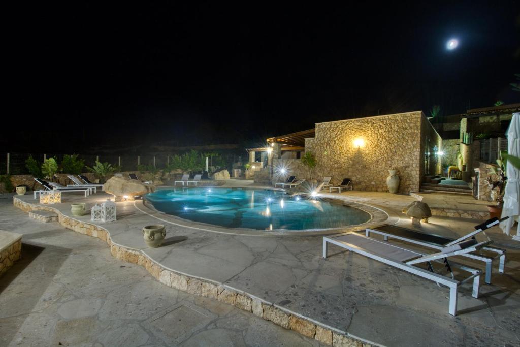 a swimming pool in a yard at night at Residence Il Corallo - Guitgia in Lampedusa