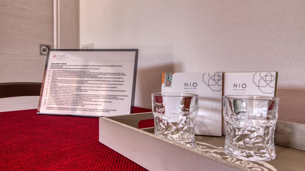a table with two glasses and a box on it at Residence Il Corallo - Guitgia in Lampedusa
