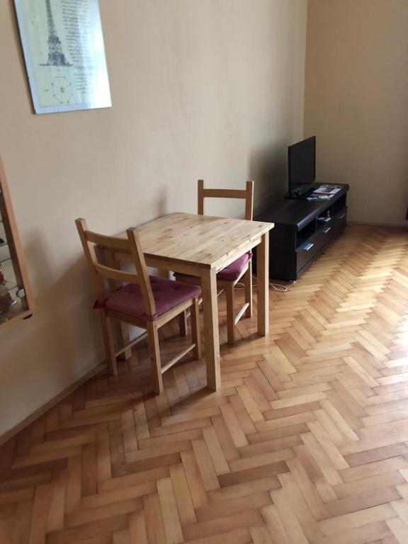 a wooden table and two chairs in a room at Ubytování v Podkrkonoší in Úpice