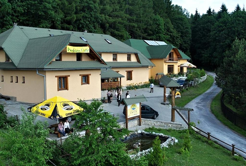 a large yellow umbrella in front of a building at Penzion Ustie in Trstená