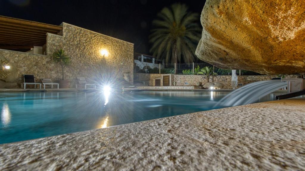 a swimming pool at a resort at night at Residence Il Corallo - Guitgia in Lampedusa