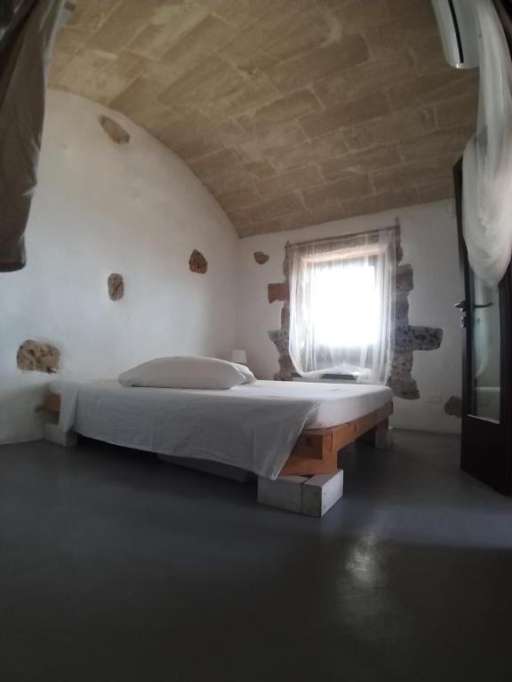Postel nebo postele na pokoji v ubytování La Torre di Merlino