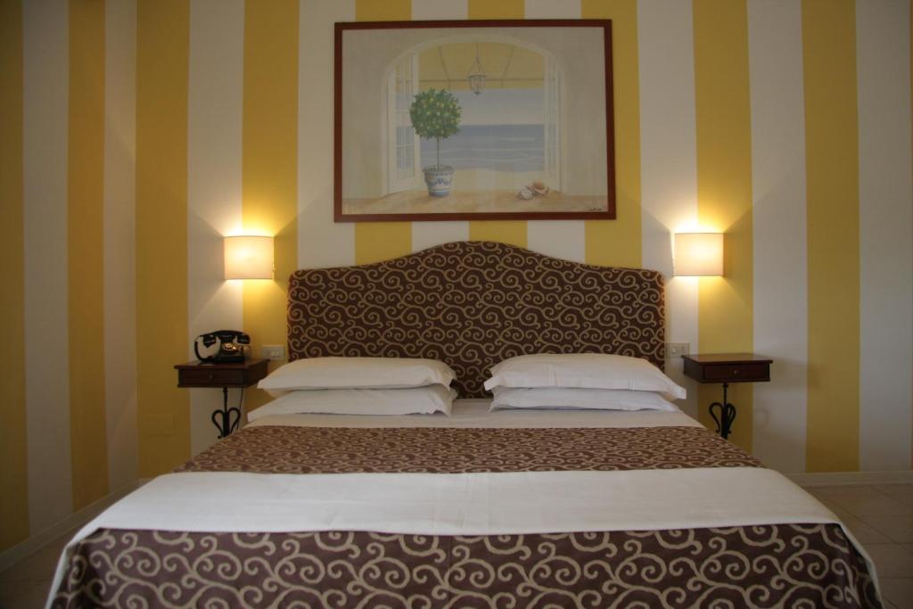 Postel nebo postele na pokoji v ubytování Hotel Alex