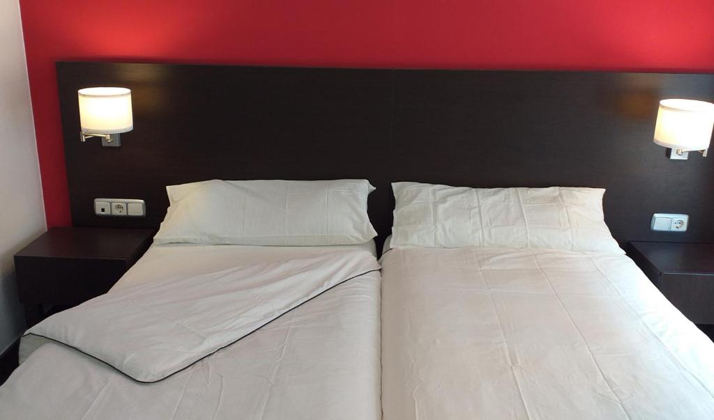 Postel nebo postele na pokoji v ubytování Hostal Meson de Paco