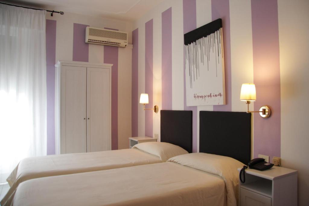 Postel nebo postele na pokoji v ubytování Hotel Alex