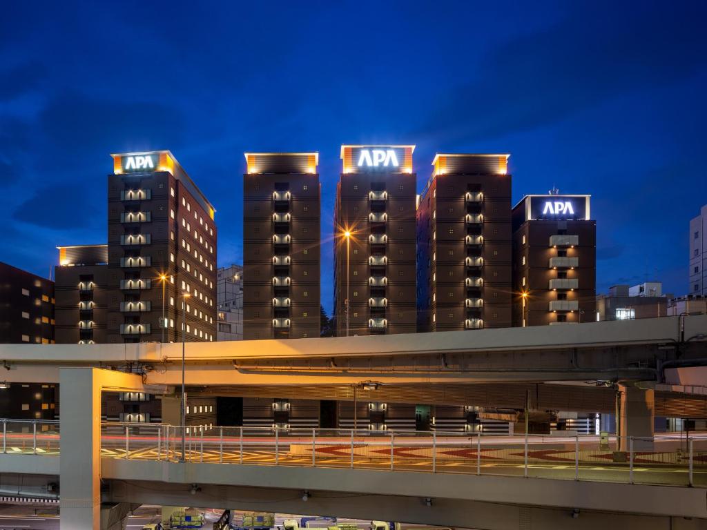 a group of tall buildings in a city at night at APA Hotel Roppongi SIX in Tokyo