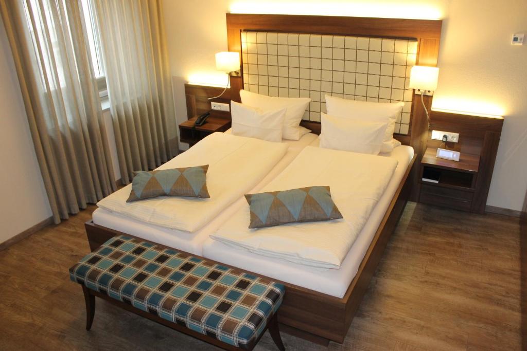 a bedroom with a large bed with two pillows at Hotel Number One in Waidhaus