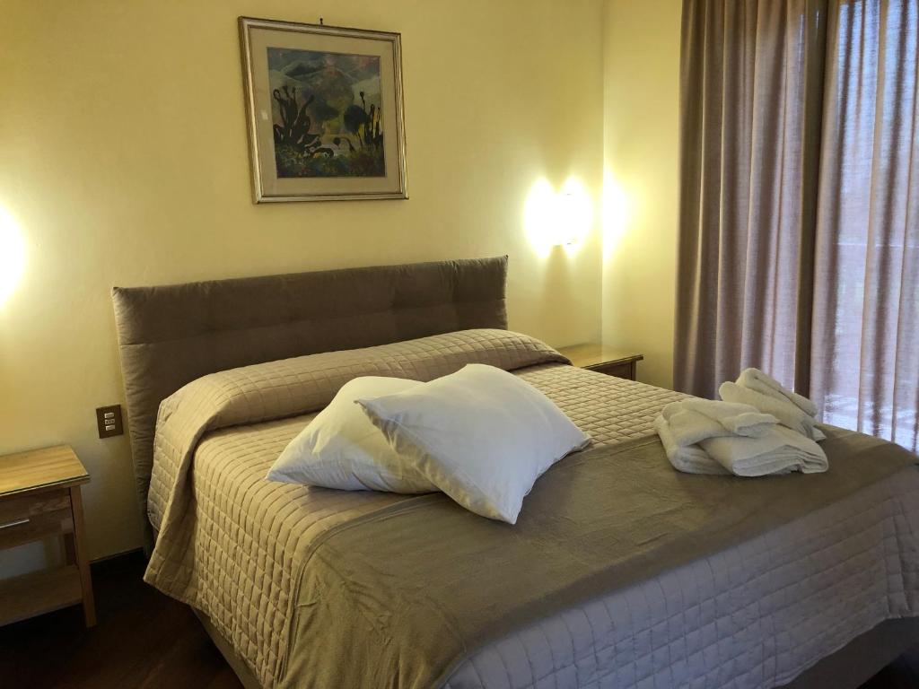 a bedroom with a bed with two pillows on it at Rayon de Soleil in Saint Vincent