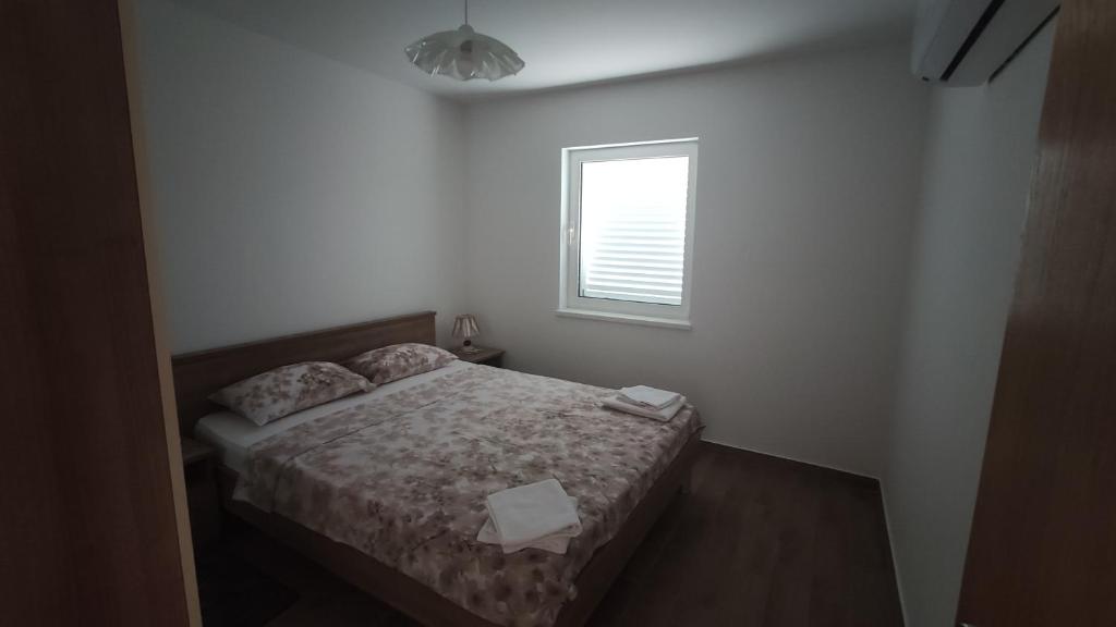 Postel nebo postele na pokoji v ubytování Apartmani Andrea