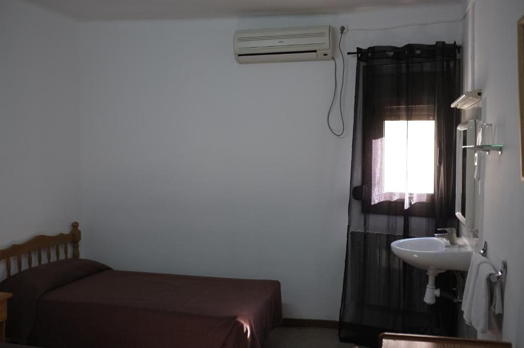 Postel nebo postele na pokoji v ubytování Hostal Europa