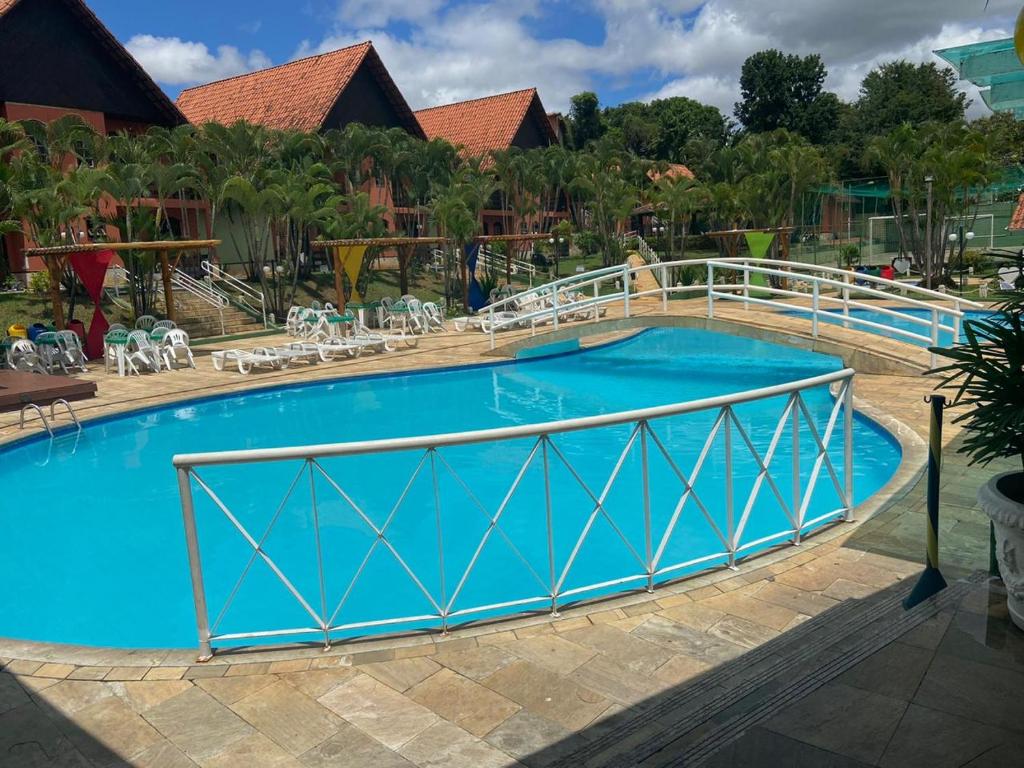 a large blue pool with a metal railing around it at Hotel Gran Minas in Vespasiano