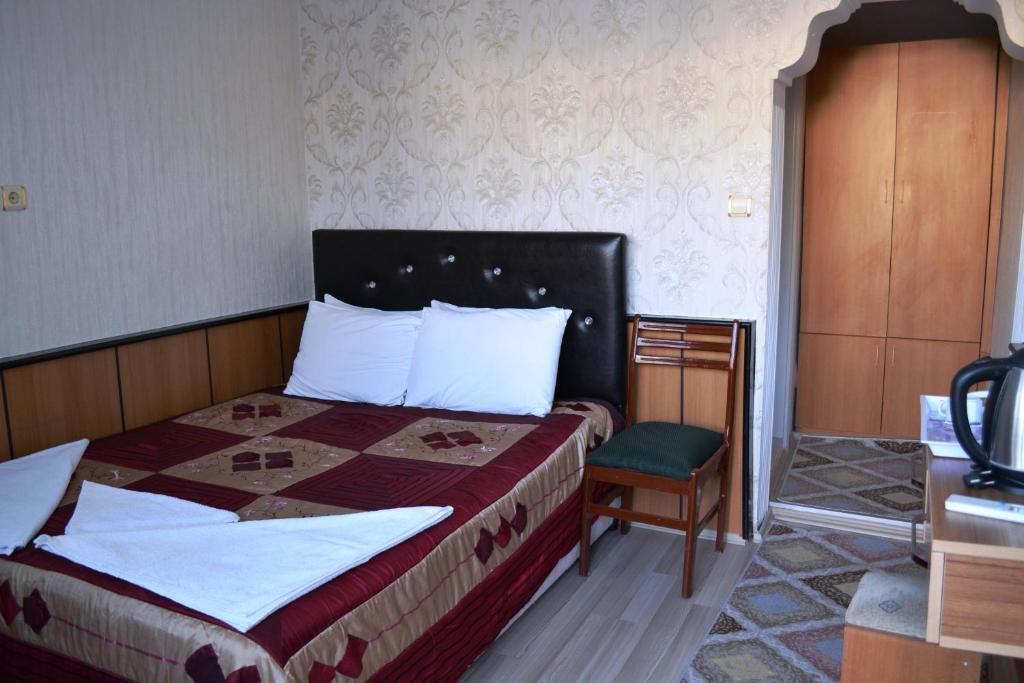 A bed or beds in a room at Aspawa Hotel