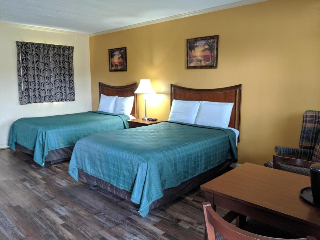 Ένα ή περισσότερα κρεβάτια σε δωμάτιο στο Cheerio Inn - Glennville