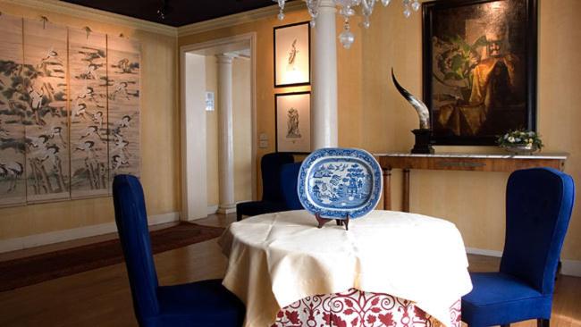 a dining room with a table and blue chairs at Hotel Due Mori in Cittadella