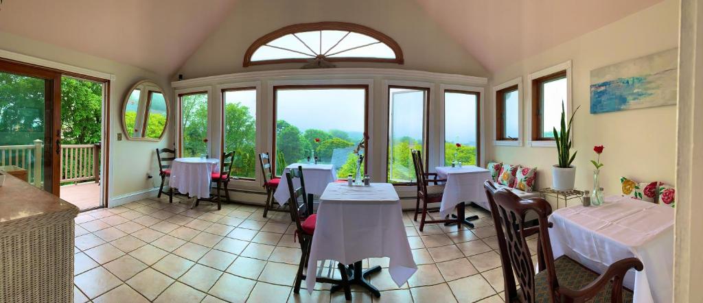 a room with tables and chairs and windows at Artful Lodger in Newport