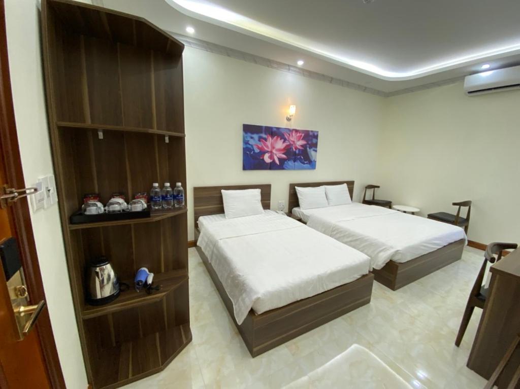 a bedroom with two beds in a room at SEN HIDDEN CHARM in Con Dao