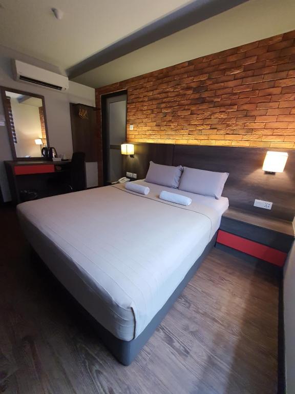 Postel nebo postele na pokoji v ubytování Cute Hotel & Dorms Ipoh