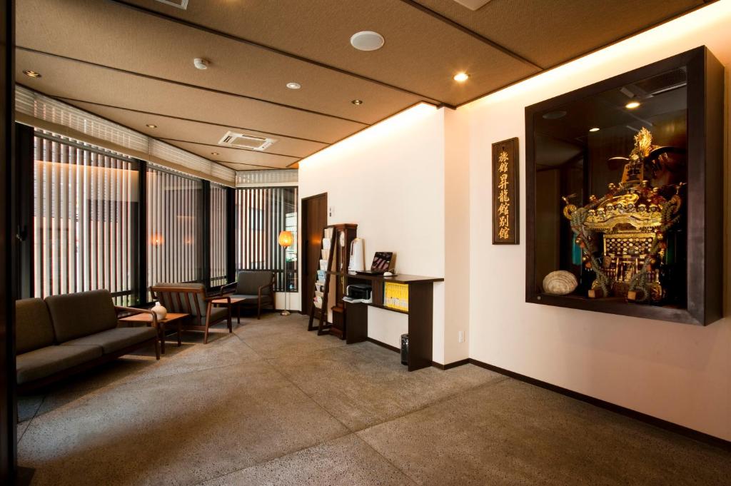 a living room with a couch and a table at Ochanomizu Hotel Shoryukan in Tokyo