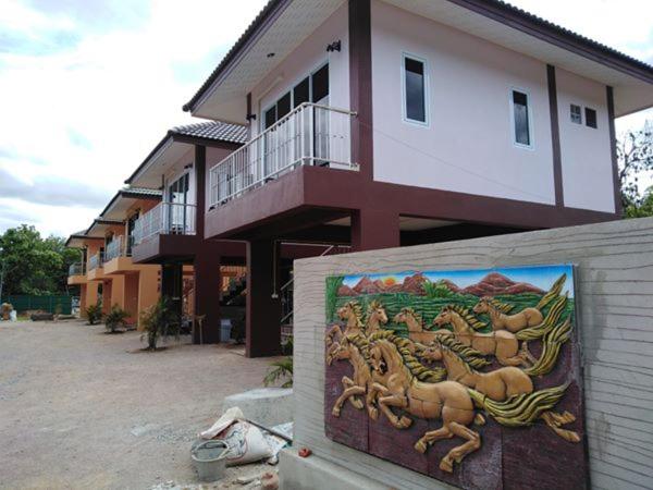 a building with a painting in front of it at Lampang Ngeng Na Home in Lampang