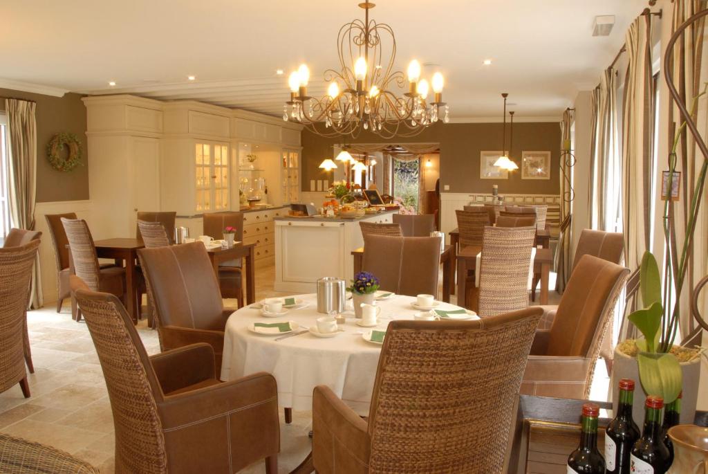 a dining room with a table and chairs at Hotel Eifelland in Butgenbach