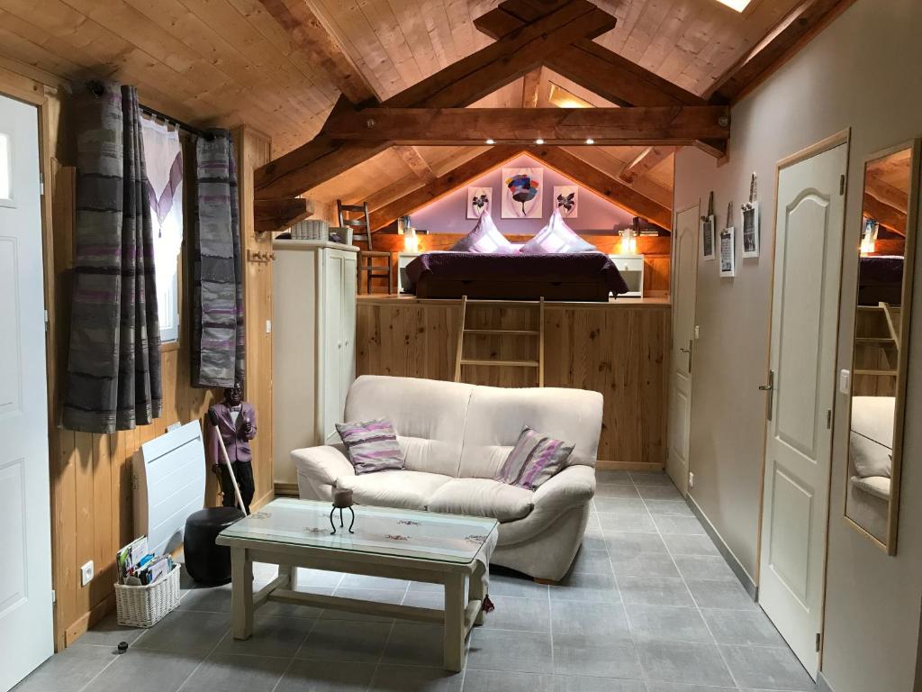 a living room with a couch and a table at Moulin de Record in Ferrières