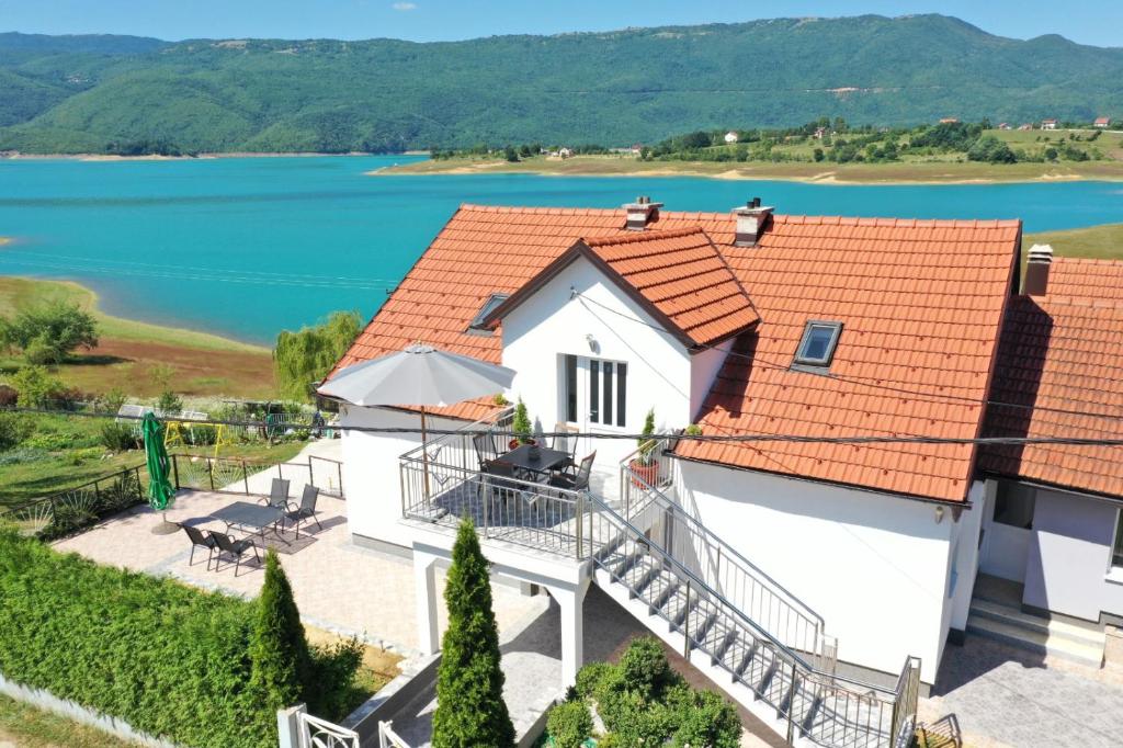 an image of a house with a view of a lake at Apartmani Markešić Ramsko jezero in Prozor